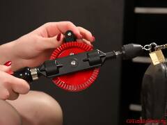 Mistress Nyxon gets creative with a classic hand drill that involved nipple clamps and one very twisted up cock. She then adds electro-pads to her slaves balls and shocks him so bad he can barely stay in position.